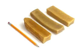 Jumbo Yak Chews next to a pencil for comparison