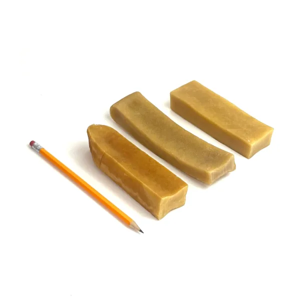 Jumbo Yak Chews next to a pencil for comparison