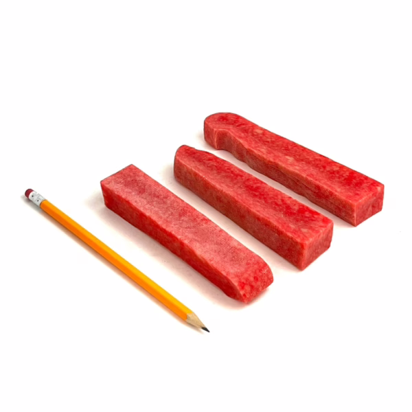 Strawberry Yak Chews next to a pencil for comparison