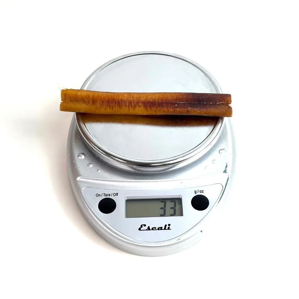 6" Bully Sticks - Slightly Overcooked **Tend To Chew Through More Quickly** | Mid-Jumbo (~20-50g) | Very Low Odor 3 6" straight bully sticks, mid-jumbo, very low odor, slightly overcooked, on a scale